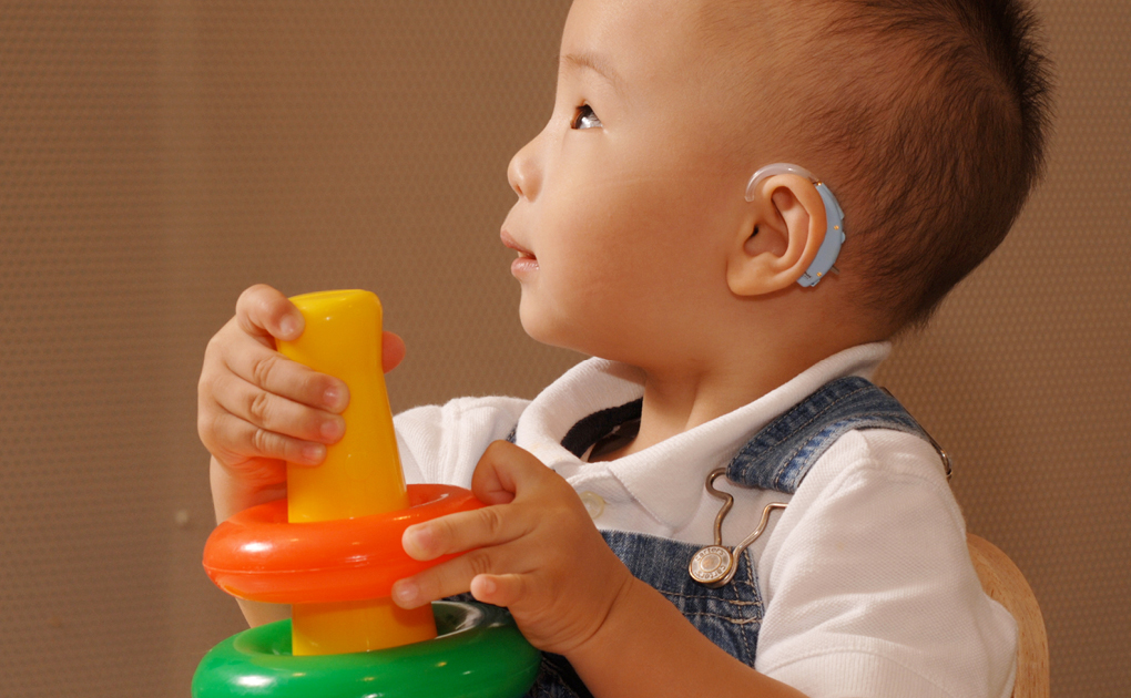 Young boy wearing a hearing aid